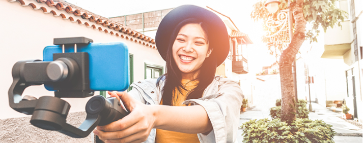 Woman holding phone on selfie stick
